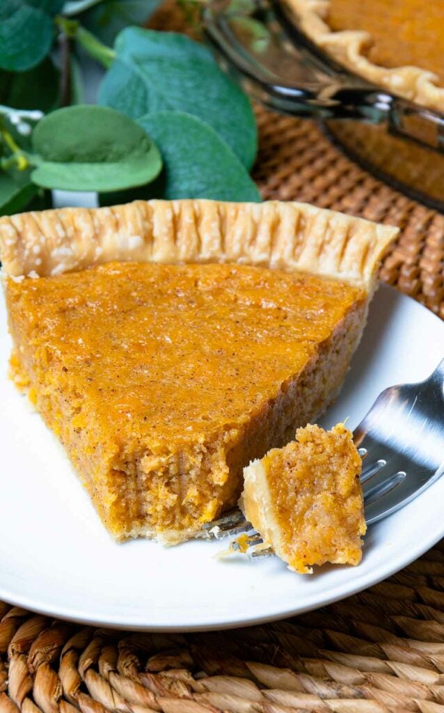 Slice of classic Sweet Potato Pie with a fork for dessert.