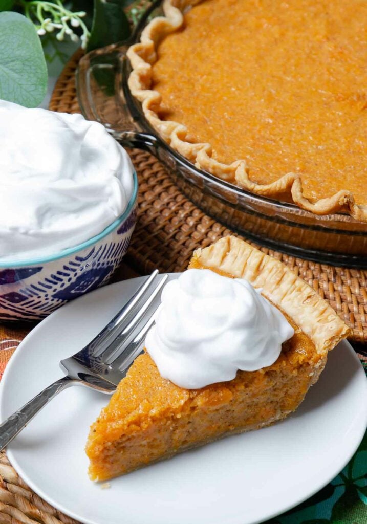Classic Sweet Potato Pie with whipped cream for dessert at Thanksgiving.