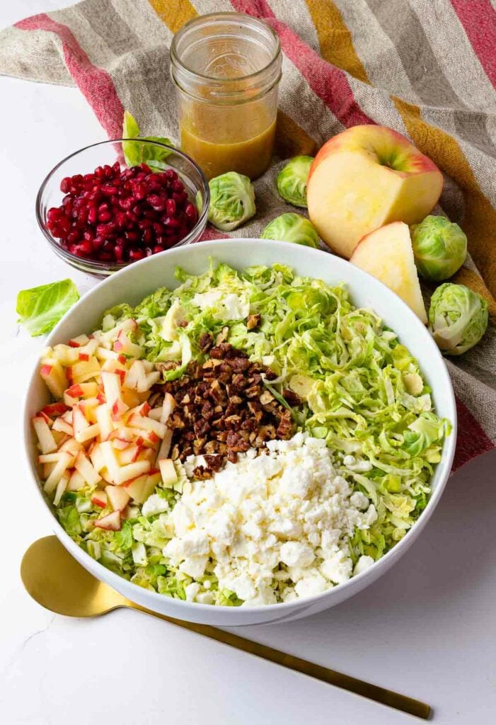Brussels Sprouts Slaw with pomagranet, apples, pecans and dressing.
