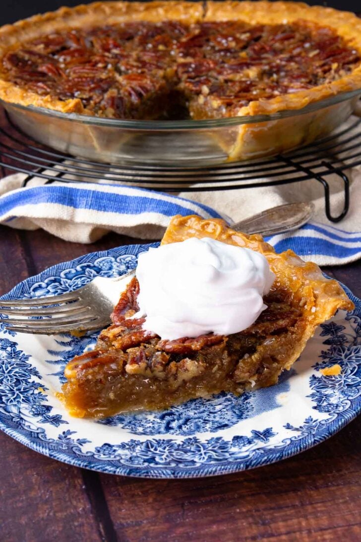 Sliced Maple Bourbon Pecan Pie on cooling rack and on plate.