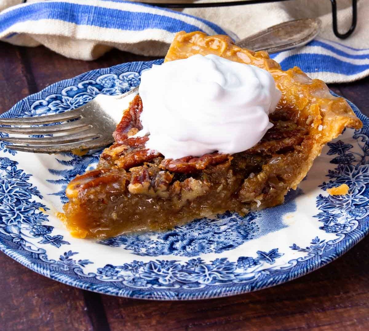 Sliced Maple Bourbon Pecan Pie on cooling rack and on plate.