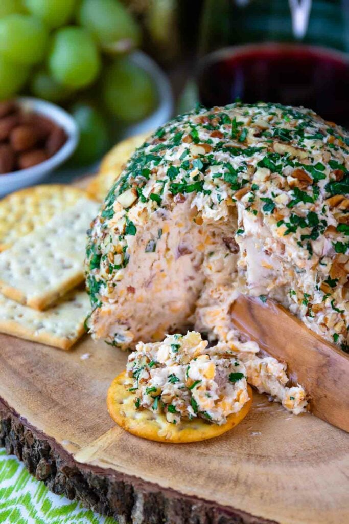 Close up of Pineapple Bacon Cheese Ball served on a round cracker.