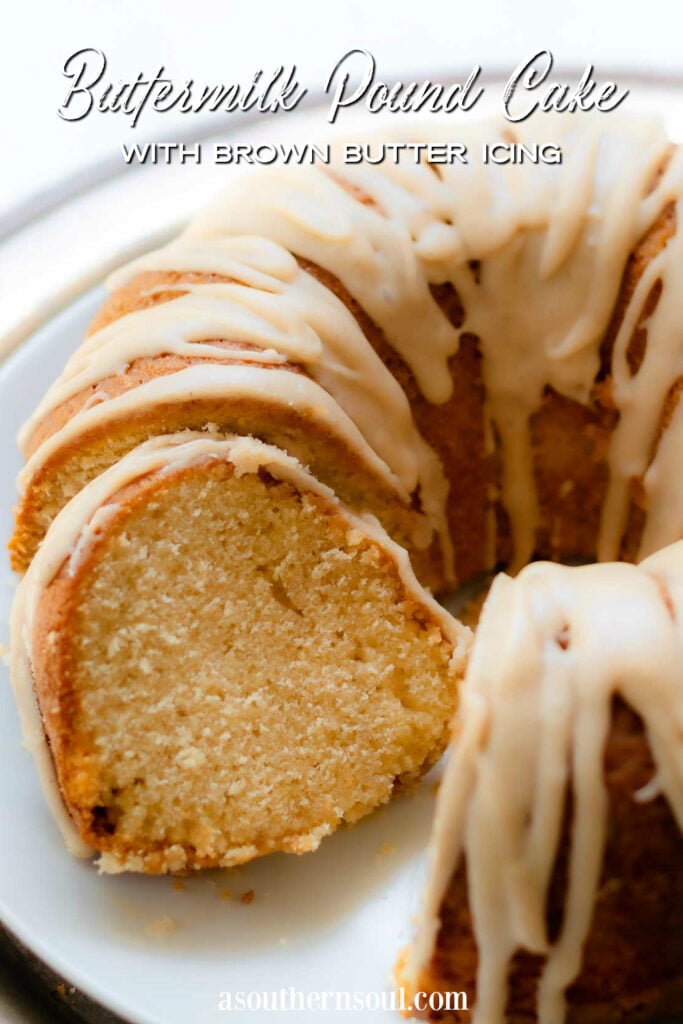 Buttermilk Pound Cake with brown butter icing on a plate with a silver cake cutter.