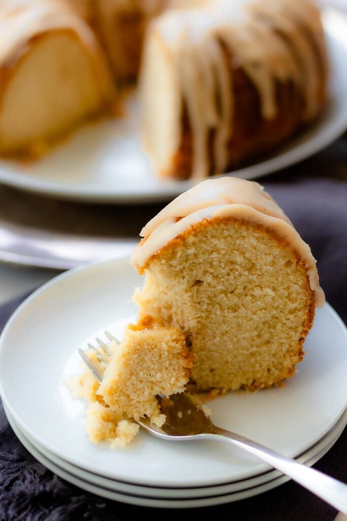 Buttermilk Pound Cake with brown butter icing sliced on a plate with a fork.