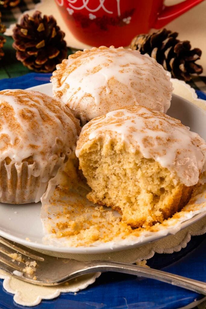 Eggnog Muffins on a plate with fork and cut in half.