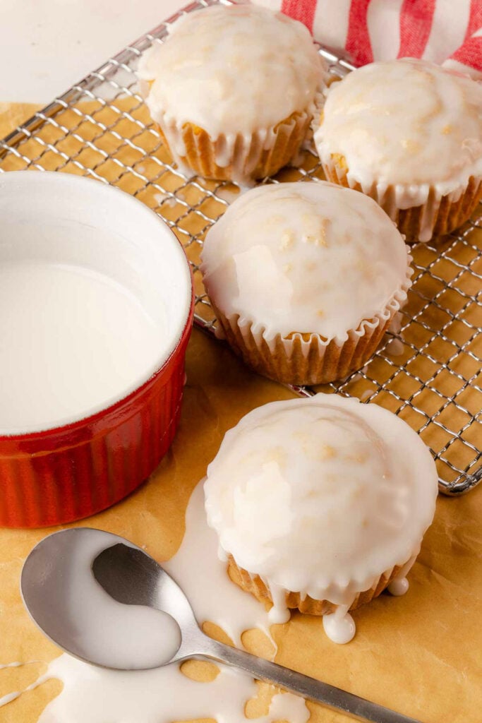 Glazed Eggnog Muffins on a cooling rack and napkin.