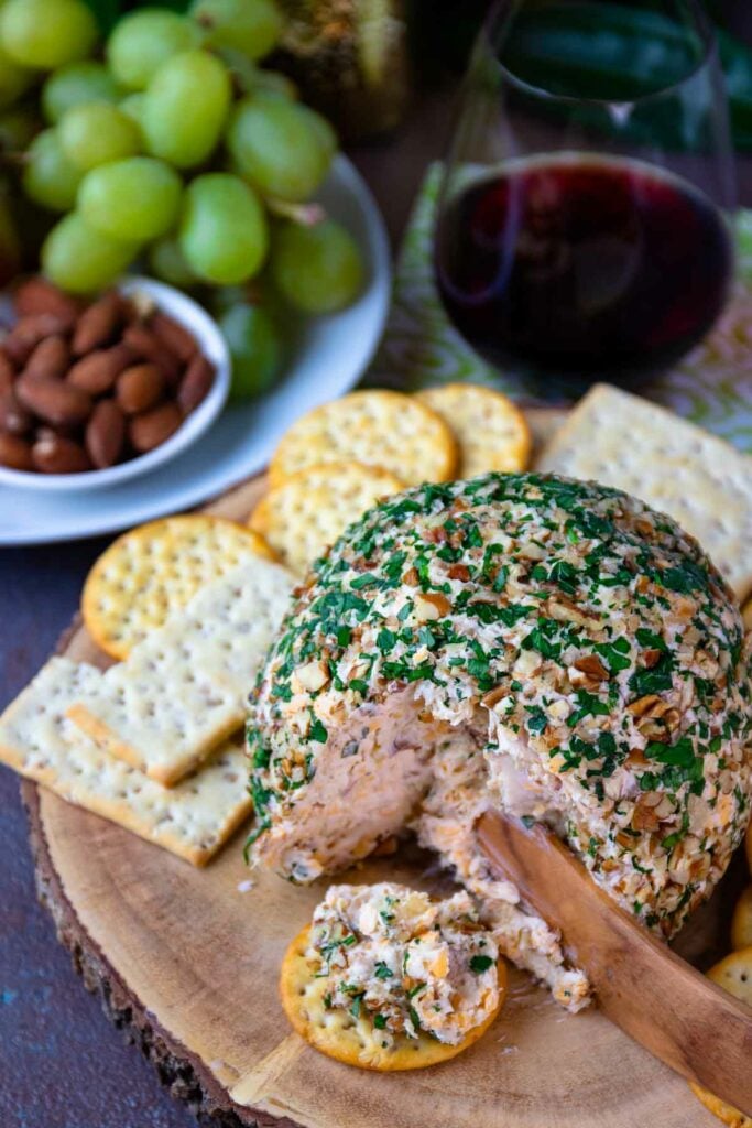 Pineapple Bacon Cheese Ball cut and served on a round cracker for cocktails.