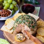 Pineapple Bacon Cheese Ball cut and served on a round cracker for cocktails.