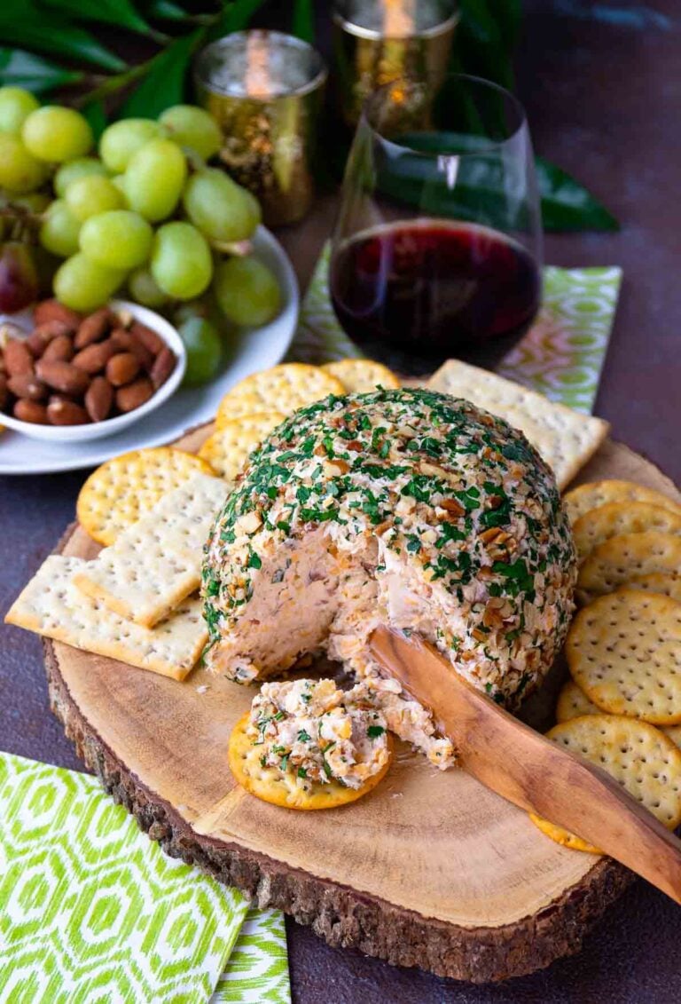 Pineapple Bacon Cheese Ball cut and served on a round cracker for cocktails.