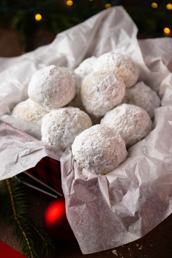 Snowball Cookies in a metal tin under the Chrismas tree.