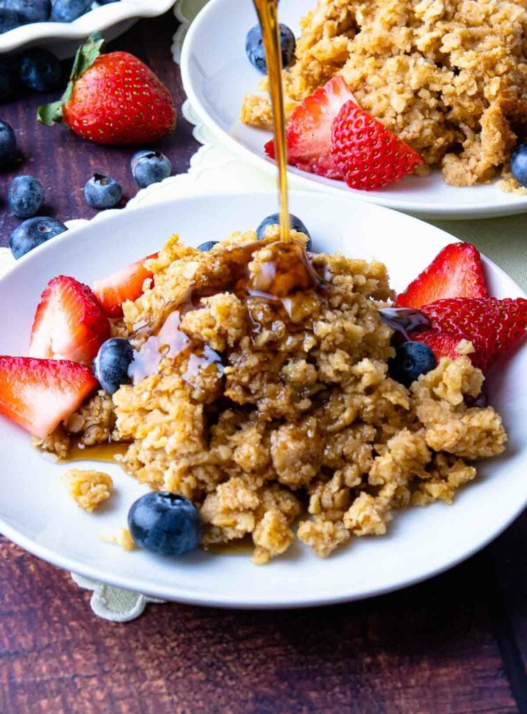 Baked oatmeal with cinnamon and a drizzle of maple syrup with berries.