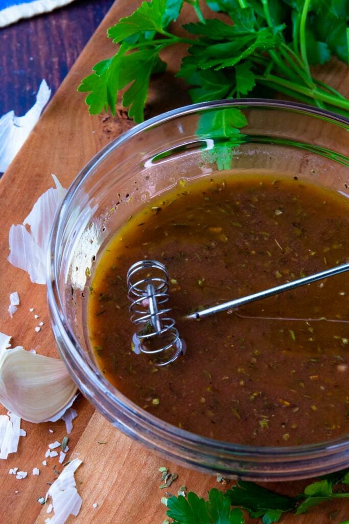 Greek Salad Dressing whisked together in a bowl.