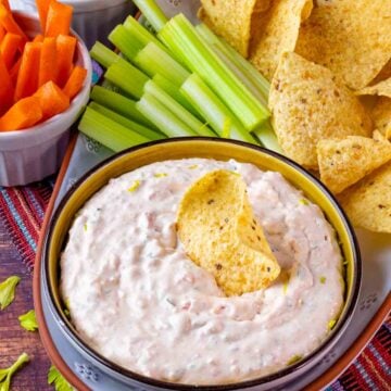 Southwest Ranch Dip served in a bowl with veggies and tortilla chips.