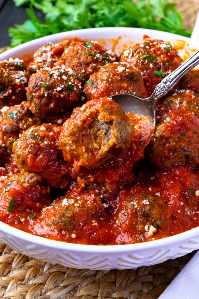 Homemade Meatballs served with a spoon.