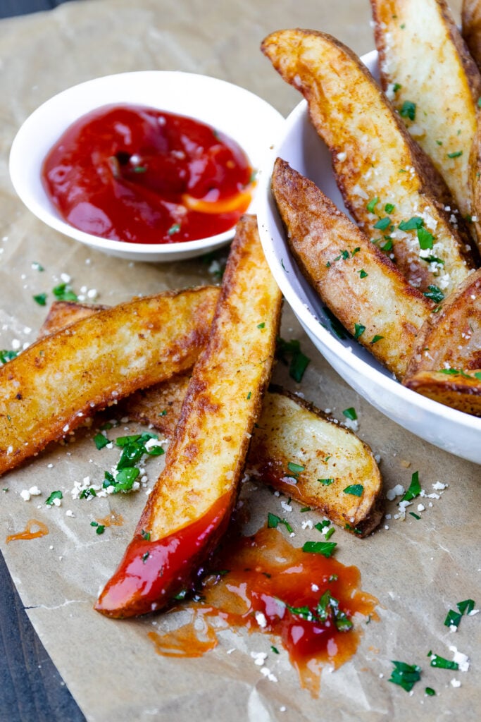 Potato Wedges cooked in the Air Fryer dipped in ketchup.