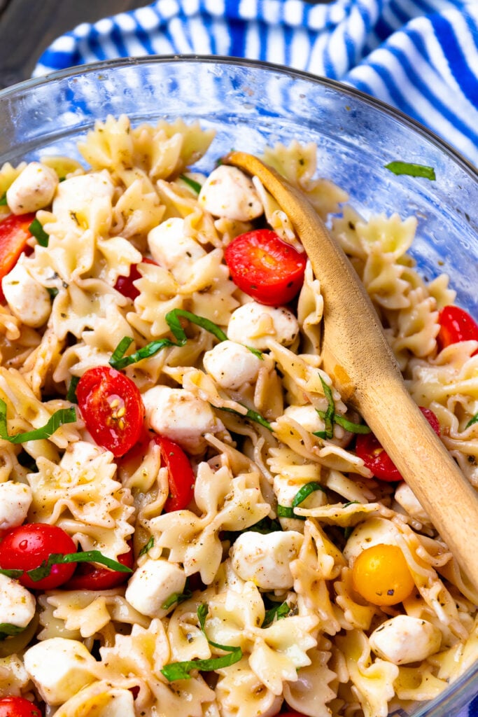 Easy to make Caprese Pasta Salad has fresh tomatoes and basil in a light dressing.