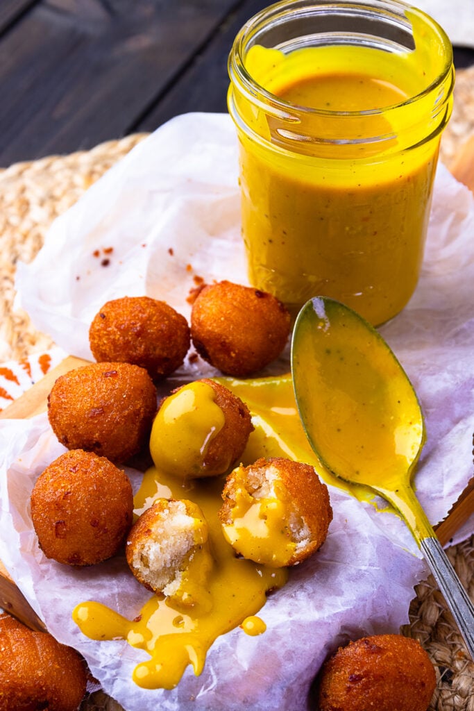 Carolina Gold BBQ Sauce served with hushpuppies.