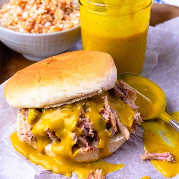 Pulled pork sandwich drizzled with Carolina Gold BBQ Sauce served with slaw.