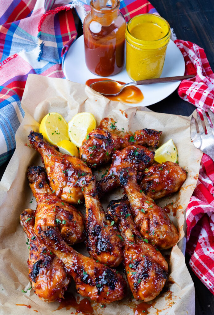 Grill BBQ Chicken Legs with homemade sauce and Carolina Gold Sauce.
