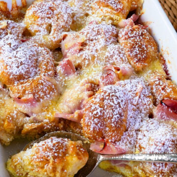 Ham and Cheese Croissant Breakfast Casserole dusted with powdered sugar for serving.