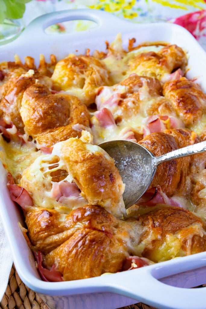 Ham and Cheese Breakfast Casserole with a spoon being served.