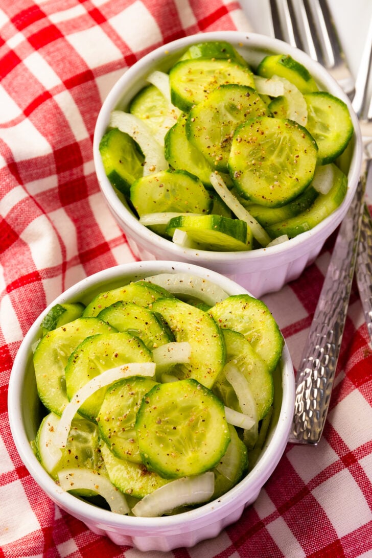 Cucumber Onion Refrigerator Pickles with forks for serving.