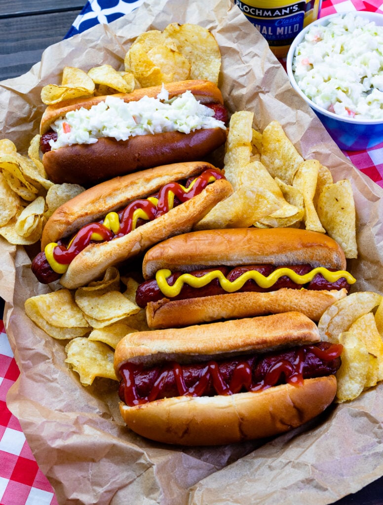 Air Fryer Hot Dogs on a tray with potato chips for Memorial Day.