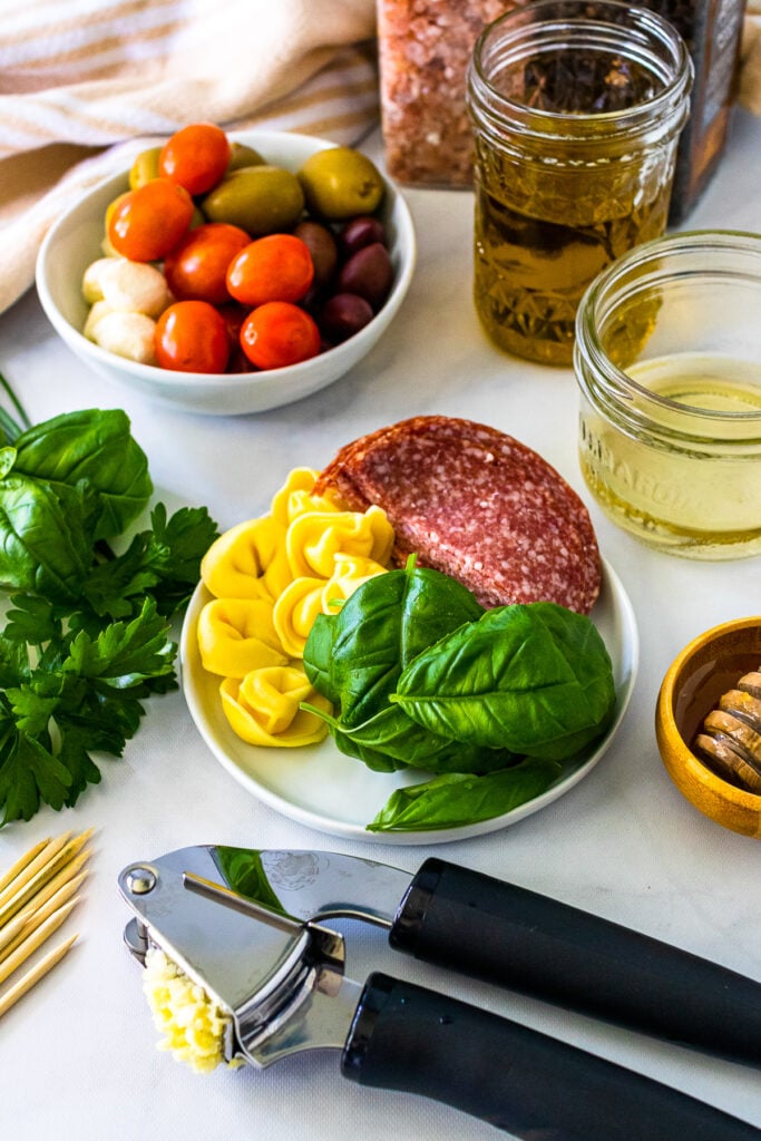 Tomatoes, salami, basil and olive for antipasto skewers