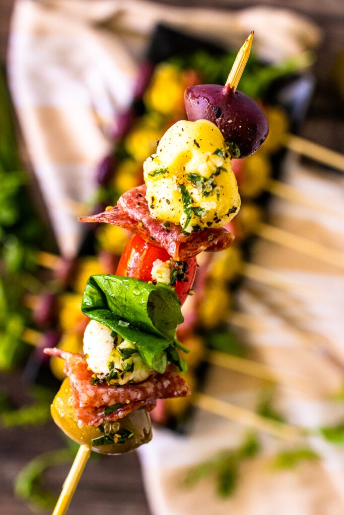 Antipasto skewers upcolse on a stick served as an appetizer.