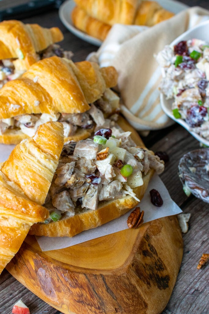 Chicken salad with chunks of chicken piled on a croissant.