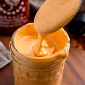 Spicy Mayo Sauce in a jar and a spoon for serving.