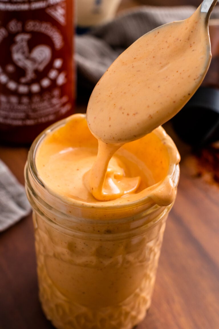 Spicy Mayo Sauce in a jar and a spoon for serving.