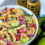 Creamy Tomato Cucumber Pasta Salad made with a simple dressing with fresh herbs and red onions.