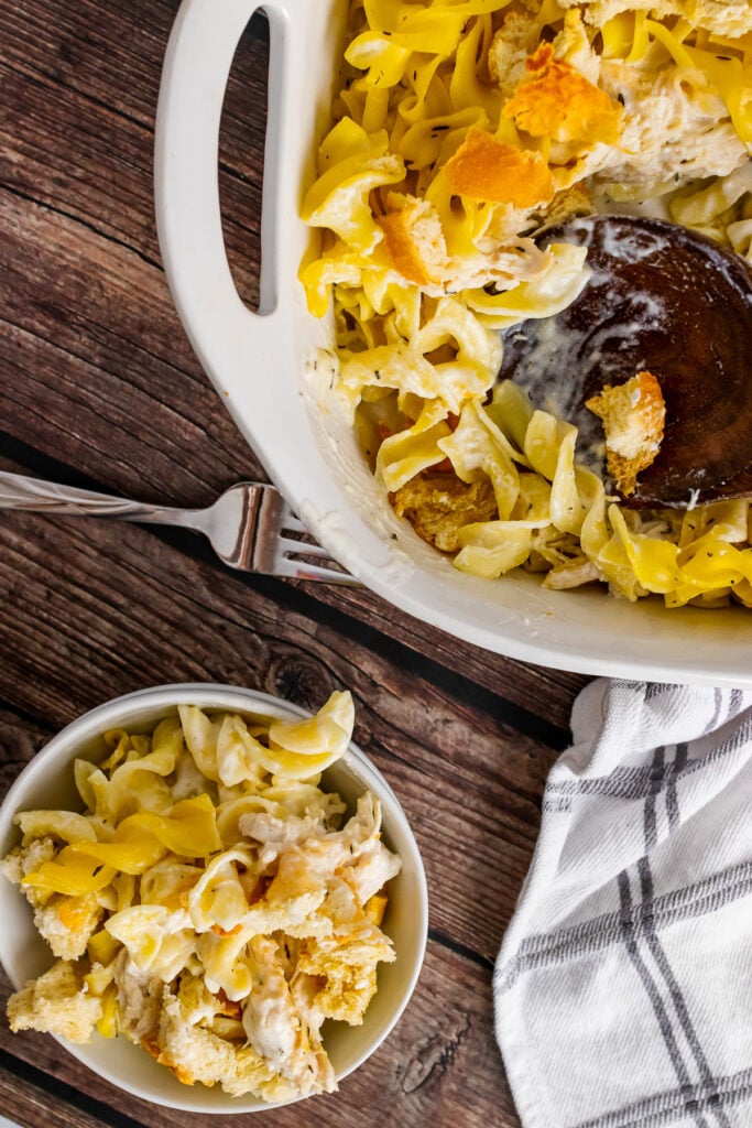 Creamy Chicken Casserole in a white casserole dish with a bowl and fork.