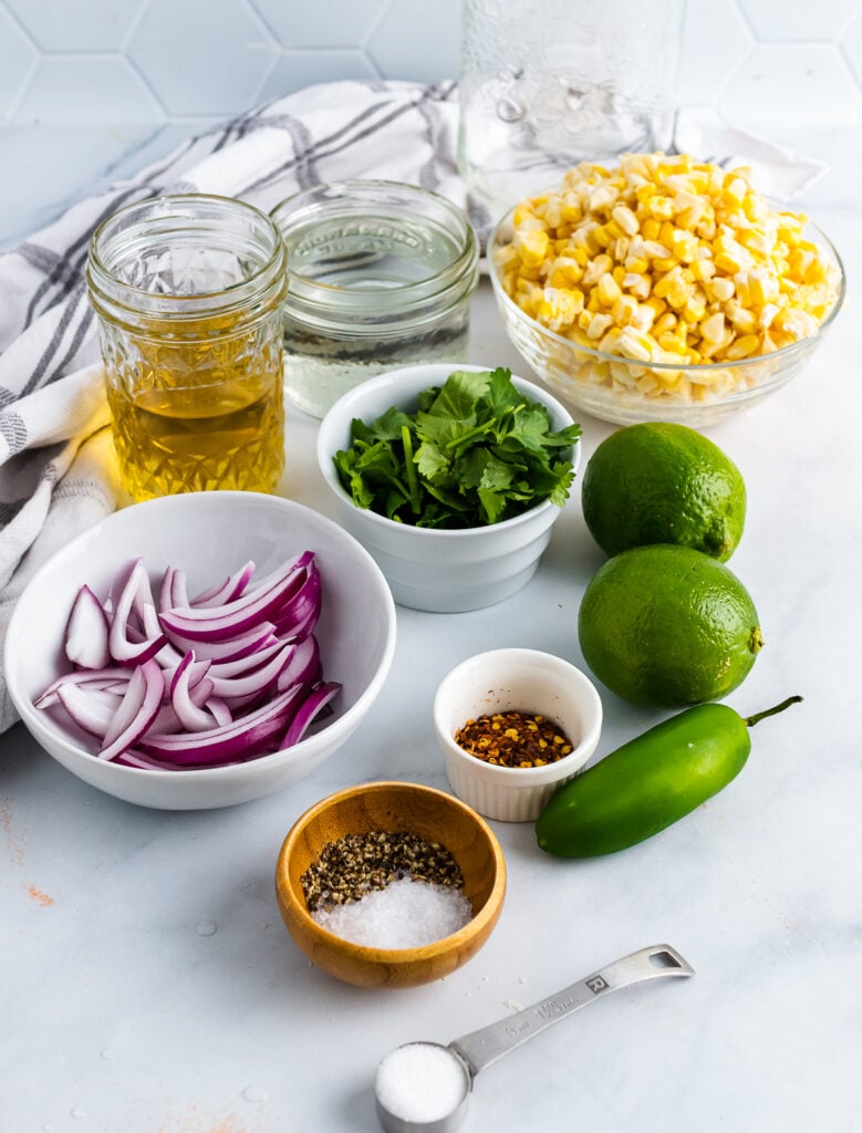 Corn, cilantrol, red onions, jalapenos, limes and spices for Pickled Corn.