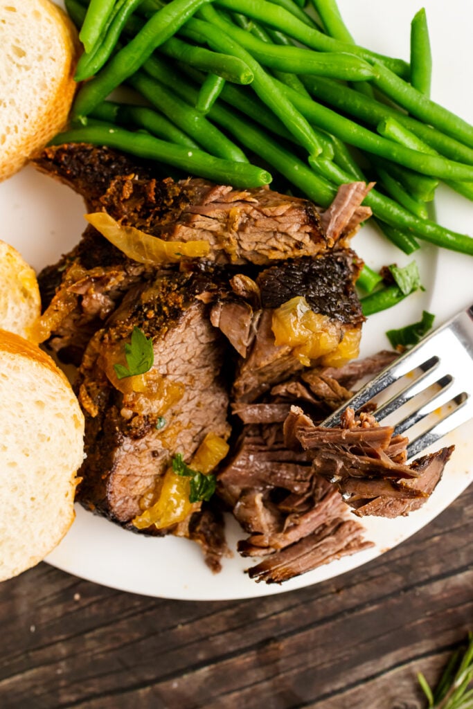 Busy Day Pot Roast on a white plate with a fork and green beans