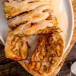 Slice of apple pull apart breat on a white plate.