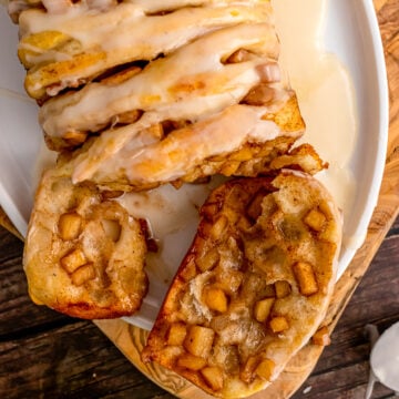 Slice of apple pull apart breat on a white plate.