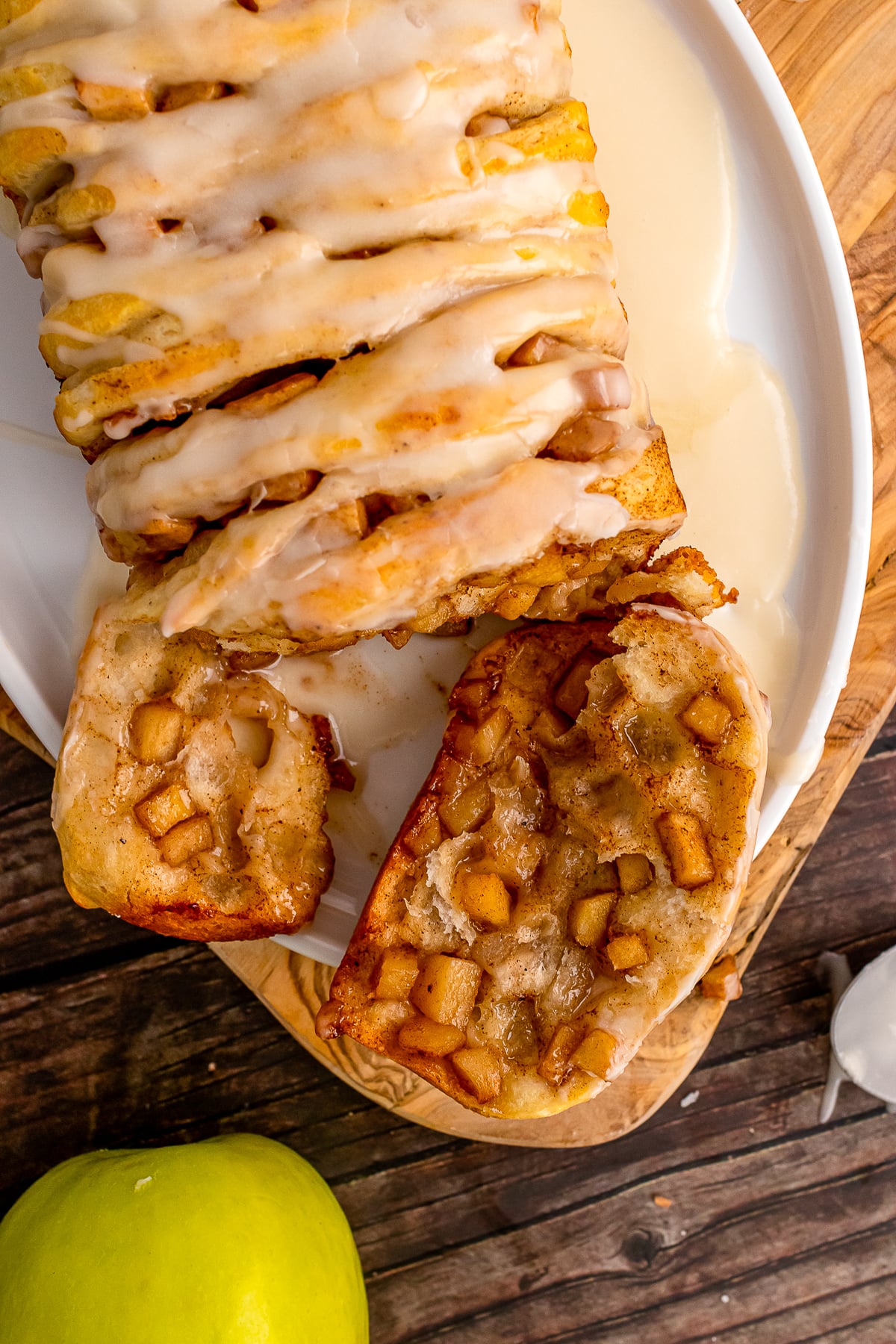 Slice of apple pull apart breat on a white plate.