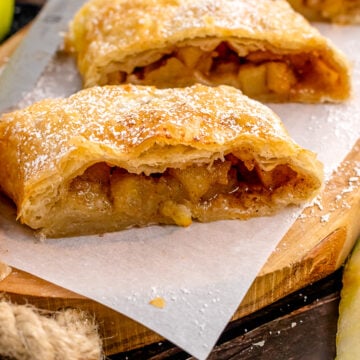 Sliced Apple Strudel on a wooden cutting board.
