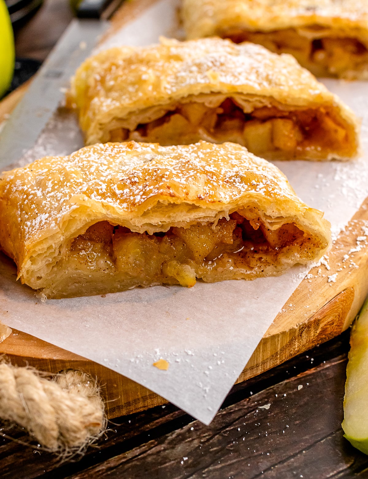 Sliced Apple Strudel on a wooden cutting board.