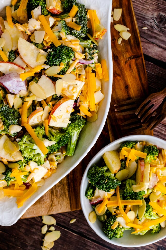 Large white bowl and small white bowl with Broccoli Apple Salad.