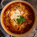 Gray stock pot with Lasagna Soup with ricotta cheese and fresh basil.