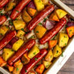 Sheet Pan Brats and Potatoes on a metal sheet pan.