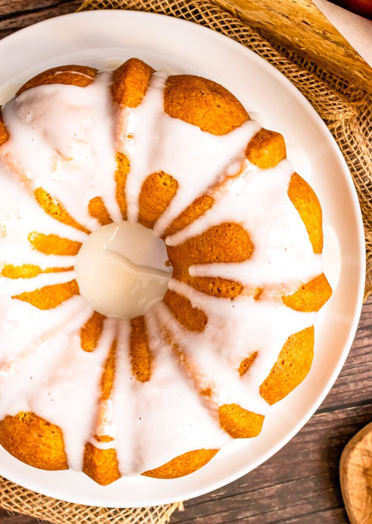 Apple Spice Cake on a plate with icing drizzle.