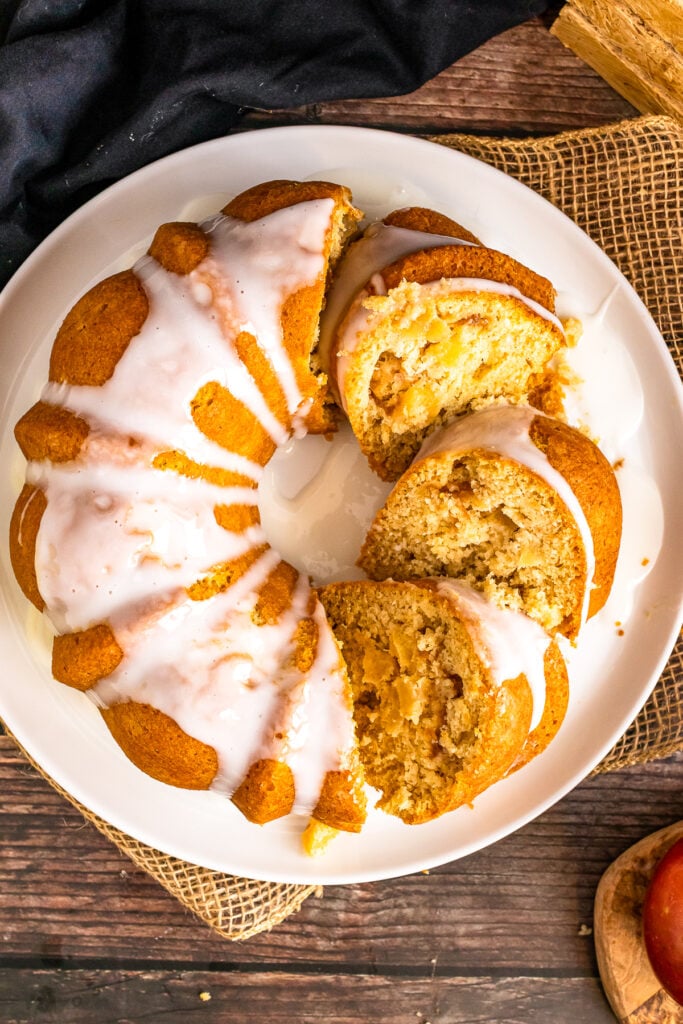 Apple Spice Cake with icing sliced on a plate.
