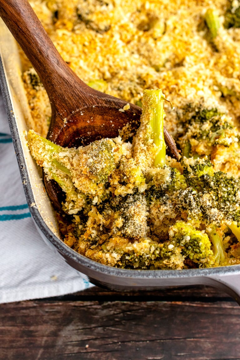 Easy to make Broccoli Casserole served with a wooden spoon for dinner.