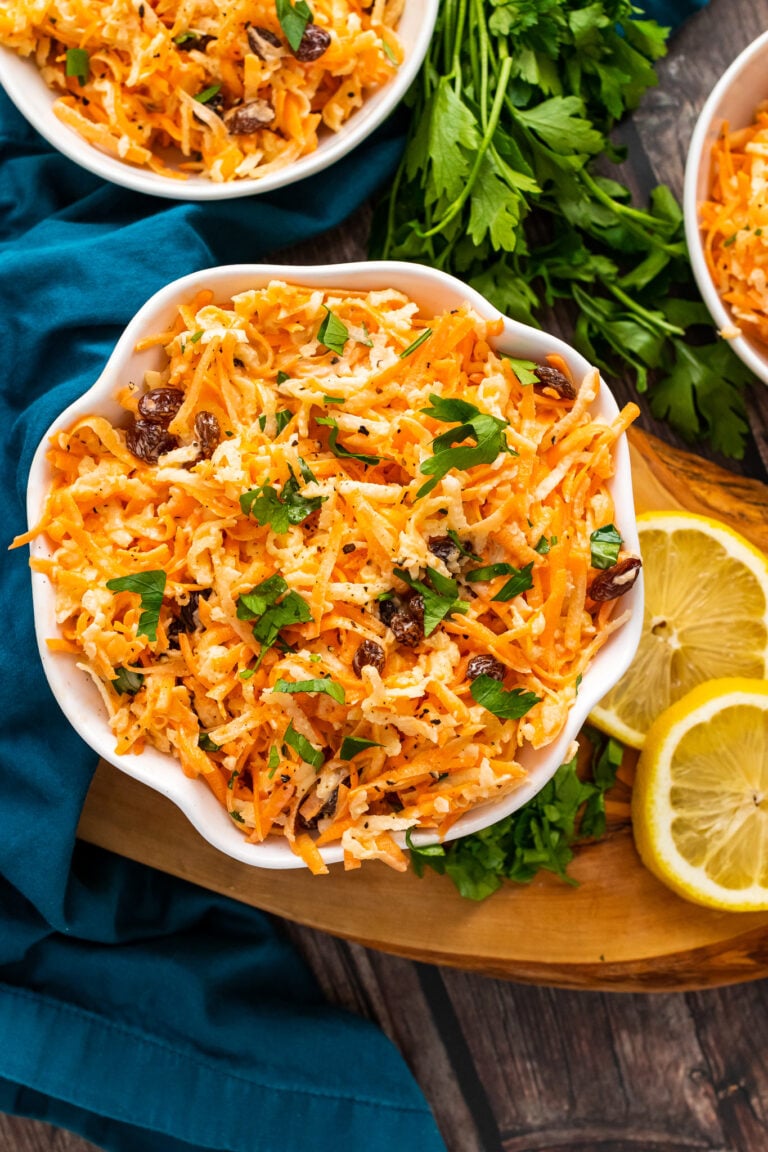 Carrot Apple Salad with fresh parsley in a white bowl.