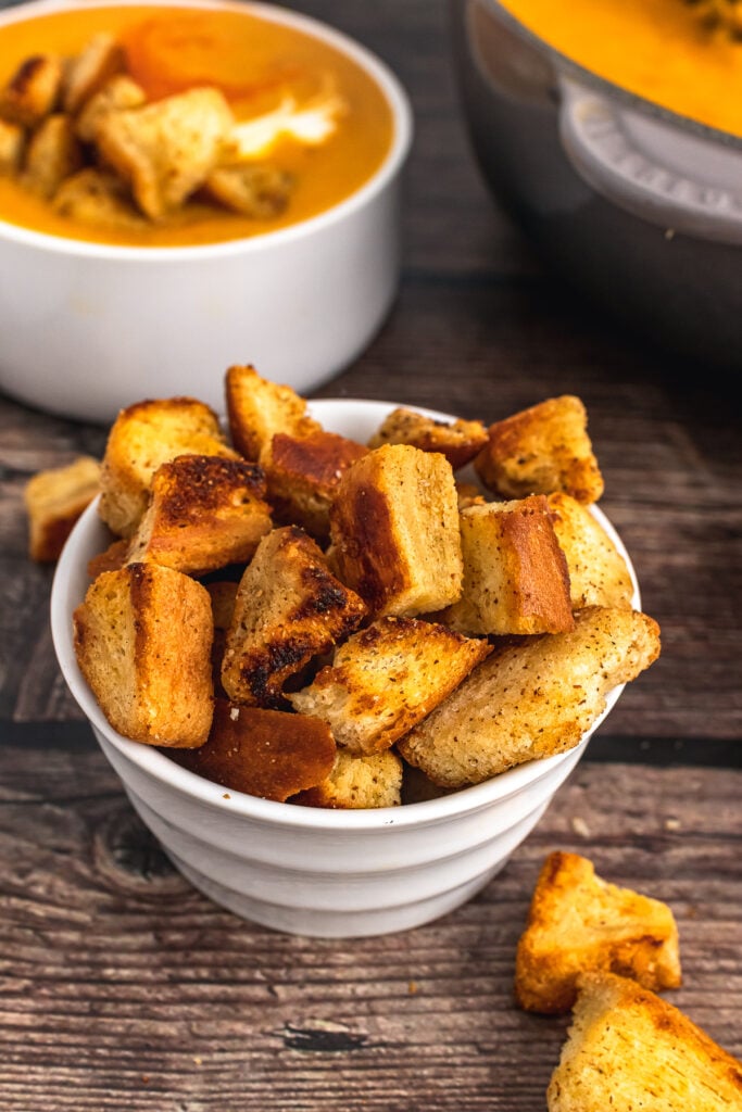 Homemade croutons in a white bowl.