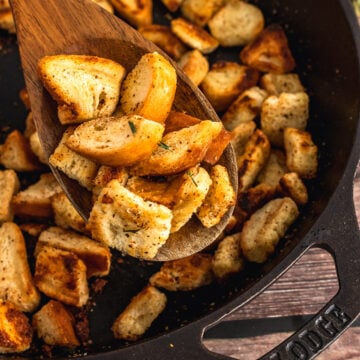 Homemade croutons served on a wooden spoon.